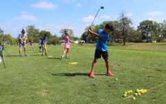 Young golfers practice their swings..