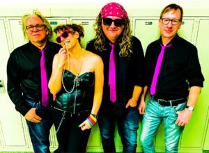 The Jolly Ringwalds in 80s gear leaning on lockers