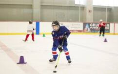 Hockey player preparing to shoot the puck.