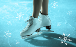 Figure skates surrounded by snowflakes