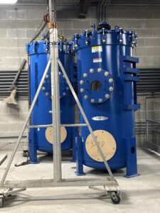 Blue pool filters ready for installation.