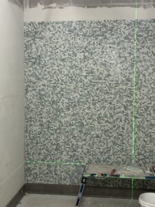 Tile shower walls for new bathrooms at Splash Landings.